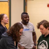 Student Life staff and student interacting